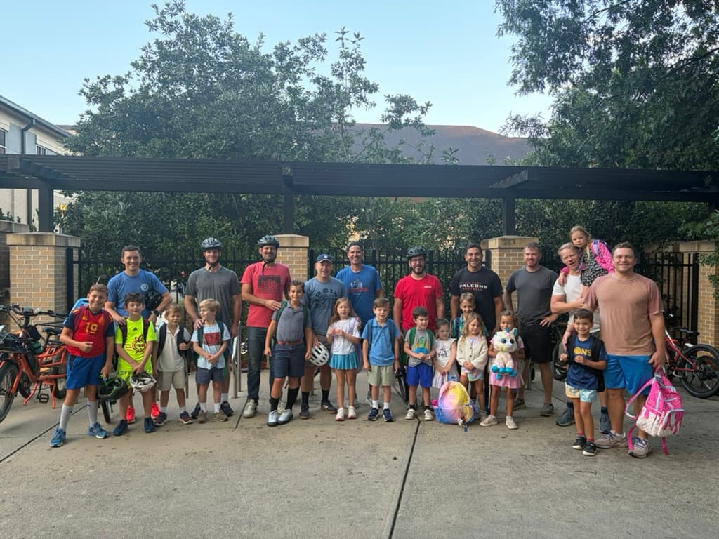 The whole crew posing at the school bike racks after a ride